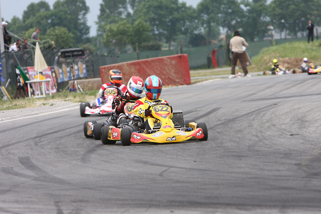 Two karts battling on outdoor circuit